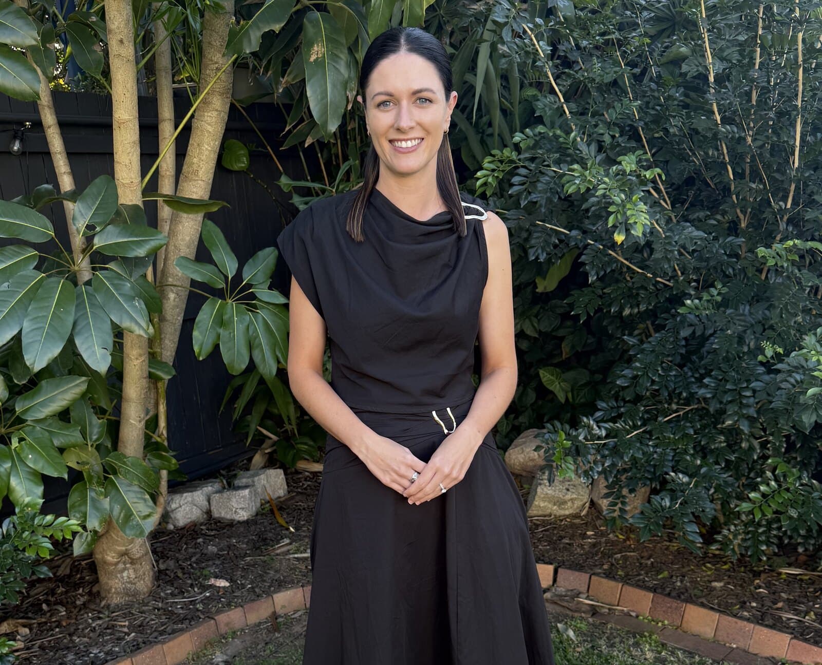 Celebrant Chloe standing in a garden, smiling